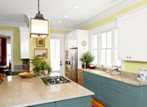 green kitchen cabinets with black countertops